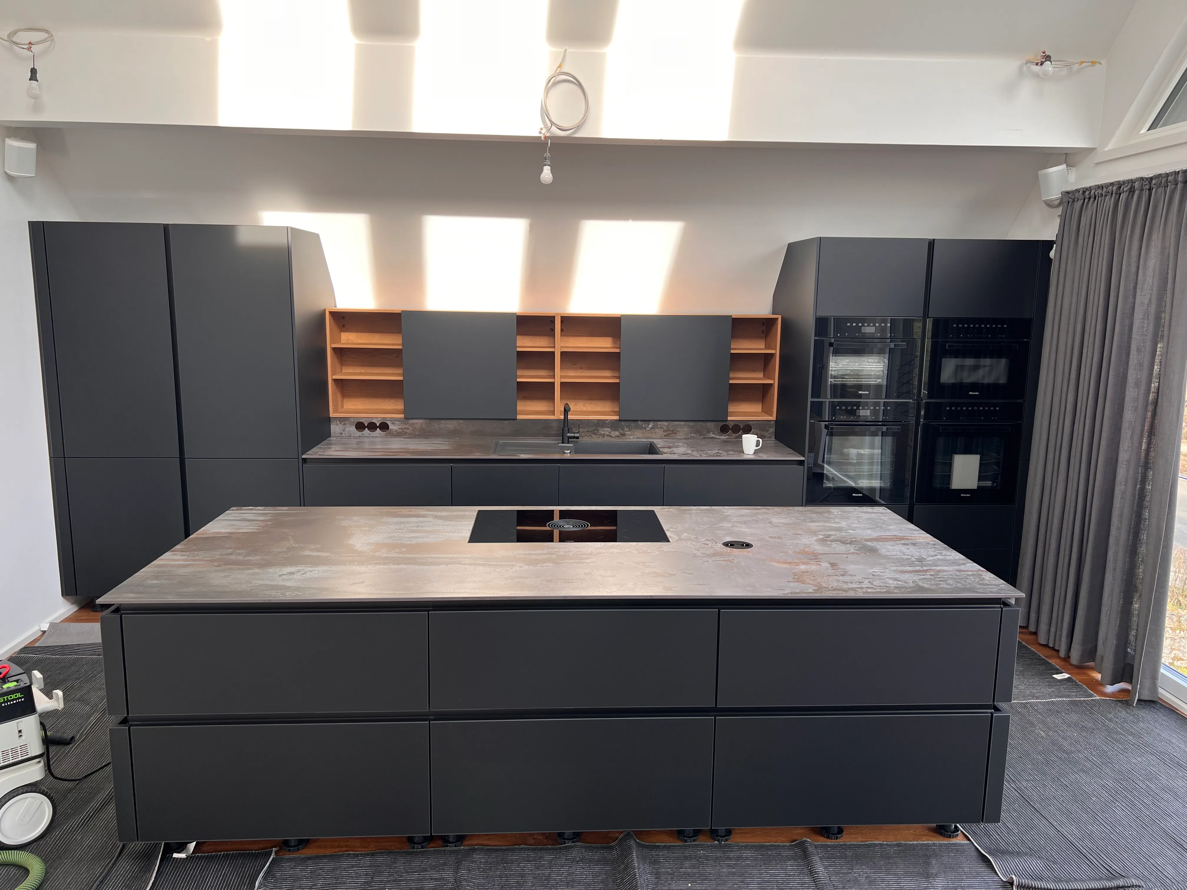 Gesamtansicht der grauen Küche mit Kochinsel